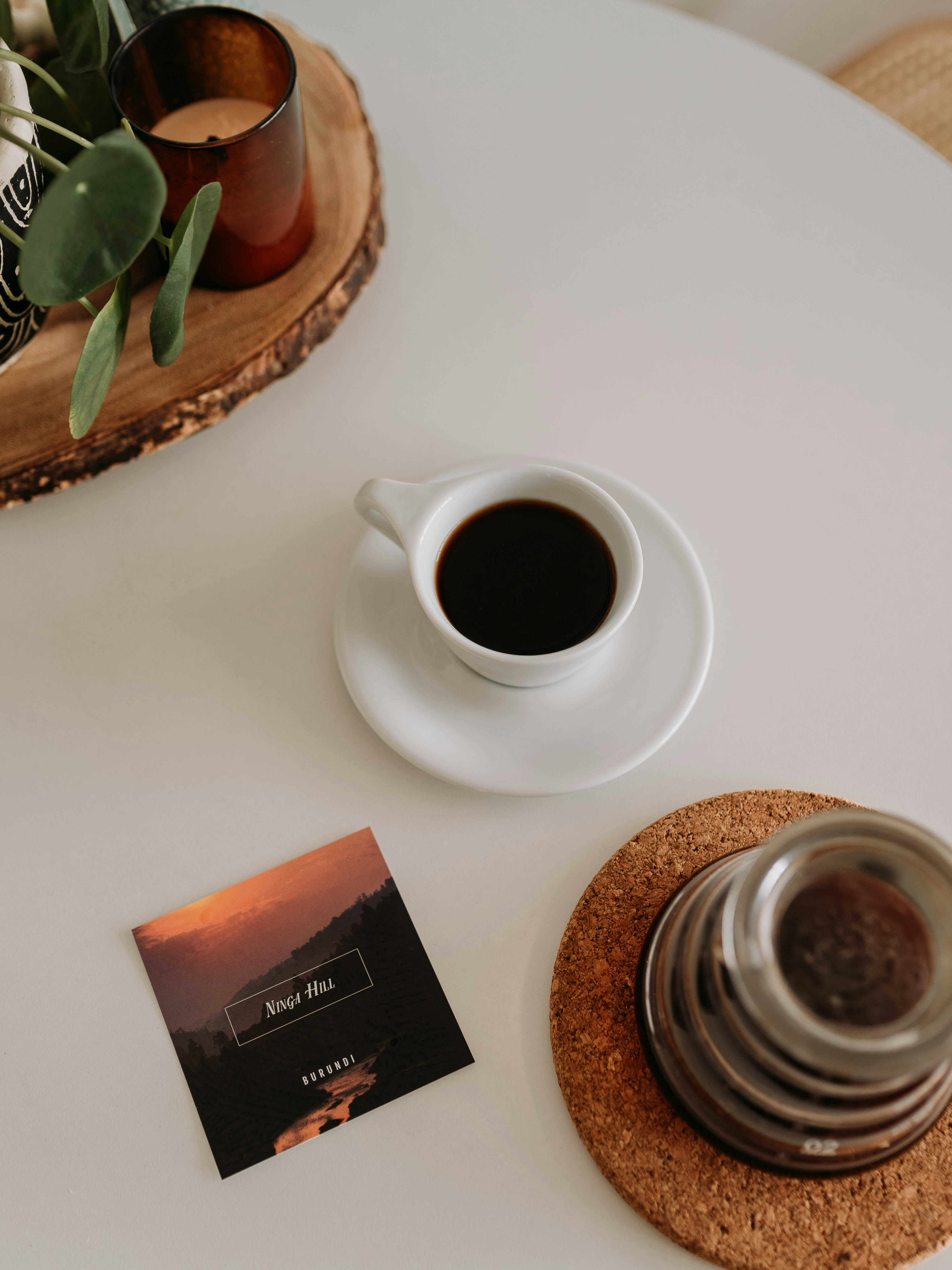 white ceramic mug on white ceramic saucer beside brown round cookies